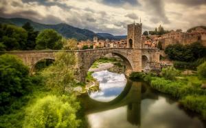 Spain, Catalonia, Fluvia river, houses, bridge, grass, clouds wallpaper thumb
