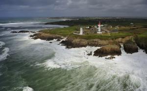 Coast town, lighthouse, rocks, waves, cloudy sky wallpaper thumb