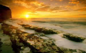 Misty sunset over the rocky shore wallpaper thumb