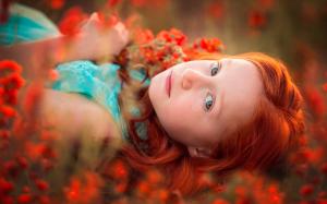 Red hair girl lying in flowers wallpaper thumb