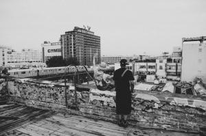 Rooftops, Buildings, City, Cityscape, Man, Sitting ,Hat, Black And White wallpaper thumb