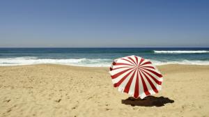 Red and white umbrella on the beach wallpaper thumb