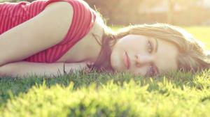 Beautiful girl lying in the grass wallpaper thumb