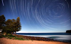 Stars Timelapse Night Trees Shore Ocean HD wallpaper thumb