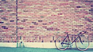 Red vintage bicycle on a stone wall wallpaper thumb