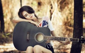 Asian guitar girl taking a break wallpaper thumb