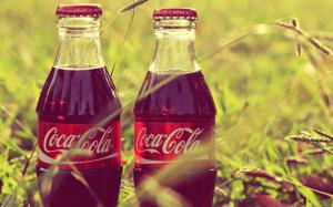 Coca Cola bottles in grass wallpaper thumb