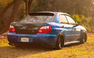 Subaru Impreza blue car back view, grass, sunlight wallpaper thumb