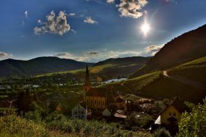 Bright Sun On A Church In A River Valley Town wallpaper thumb