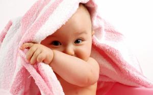 Baby behind a pink towel wallpaper thumb