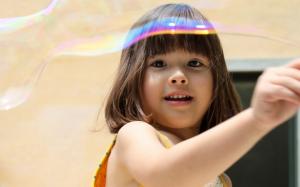 Cute girl play with soap bubbles wallpaper thumb