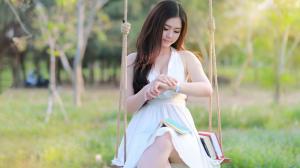 Asian girl sit at swing, white dress, books wallpaper thumb
