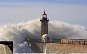 Wave Crashing A Lighthouse wallpaper thumb