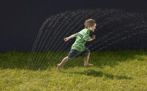 Boy Grass Running Water Spray Photo Download wallpaper thumb