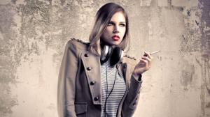 Girl smoking next to a concrete wall wallpaper thumb