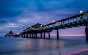 Sea, beach, pier, bridge, night, lights, blue purple sky, clouds wallpaper thumb