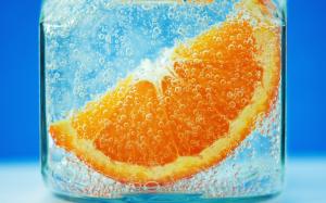Close-up of orange slices in water, blue background, glassware, bubble wallpaper thumb