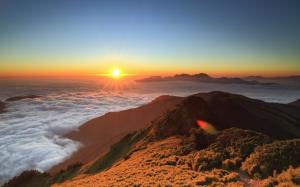 High-altitude mountain sunrise, floating clouds, sun wallpaper thumb
