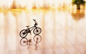 Small bicycle prototype on the wooden ground wallpaper thumb