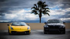 Yellow Lamborghini and black BMW cars front view wallpaper thumb