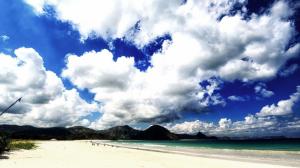 Foamy clouds over tropical beach wallpaper thumb
