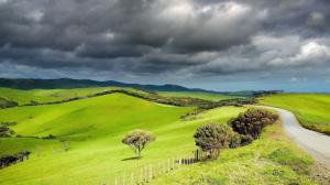 Stormy Clouds Over the Green Hills wallpaper thumb