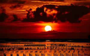 Sunset, sea, columns, fences, nets, clouds, red sky wallpaper thumb