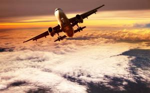 Passenger plane flying on clouds top wallpaper thumb
