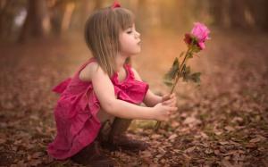 Cute little girl holding rose flower wallpaper thumb