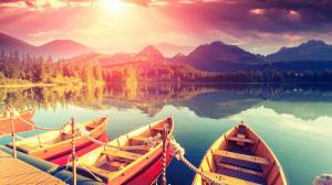 Lake, boats, pier, mountains, trees, water reflection, sunset, clouds wallpaper thumb