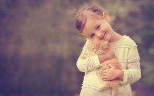 Cute girl holding a cat, smile wallpaper thumb