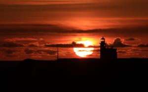 Lighthouse Sunset Clouds Silhouette HD wallpaper thumb