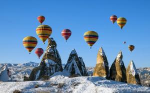 Balloons over Snowy Cappadocia Turkey wallpaper thumb