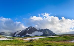 Mountains, snow, grass, beautiful highlands, clouds, blue sky wallpaper thumb