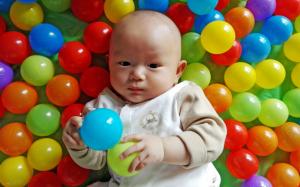 Cute baby in play balls wallpaper thumb