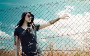 Tattooed girl at the fence wallpaper thumb