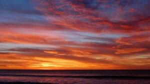 Sky meets the ocean at sunset wallpaper thumb