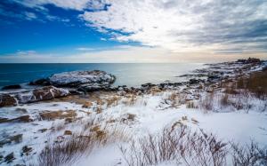 Coast in winter, white snow, sea, stones, grass, clouds wallpaper thumb