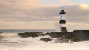 Lighthouse On A Rough Shore In Wales wallpaper thumb