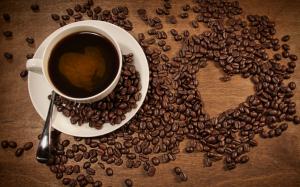 A cup of coffee, coffee beans placed heart-shaped pattern wallpaper thumb