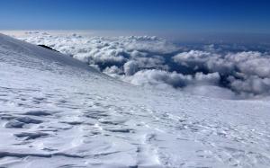 Snowy mountain peak above the clouds wallpaper thumb