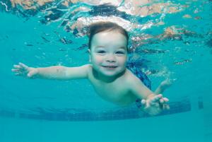 Cute Small Kid Swimming in Water Photo wallpaper thumb