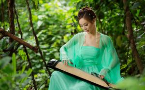 Asian girl playing the zither wallpaper thumb