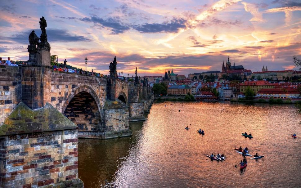 Boat Racing On The River In Prague At Sundown wallpaper,spectators HD wallpaper,river HD wallpaper,boats HD wallpaper,city HD wallpaper,bridge HD wallpaper,clouds HD wallpaper,sundown HD wallpaper,nature & landscapes HD wallpaper,1920x1200 wallpaper