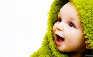 Laughing baby in a green towel wallpaper thumb
