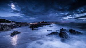 Sea, night, moon, clouds, rocks, shore, lights, blue wallpaper thumb