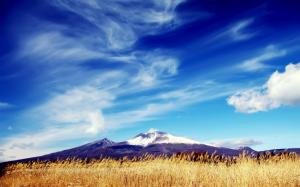 Mountains, fields, blue sky, white clouds wallpaper thumb