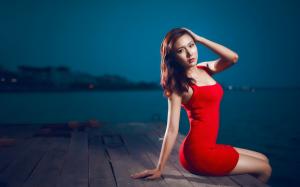 Red dress asian girl sitting at pier night wallpaper thumb