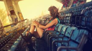 Girl sitting in an empty stadium wallpaper thumb