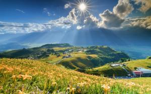 Mountain, slope, lilies flowers, sun, clouds, houses wallpaper thumb